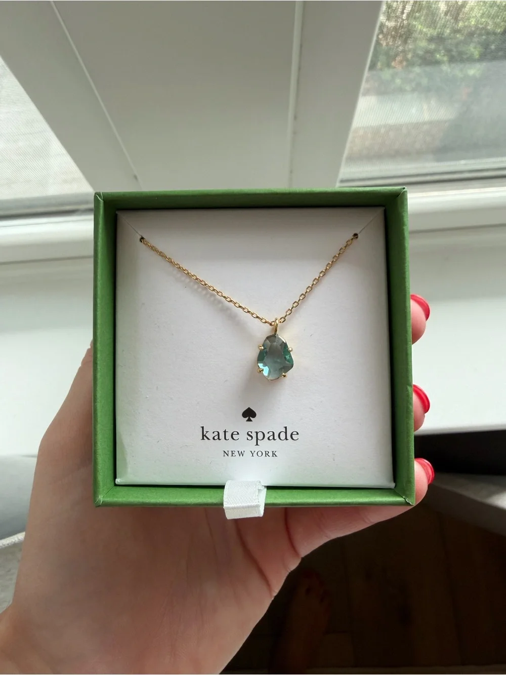 kate spade gold necklace with light blue stone pendant